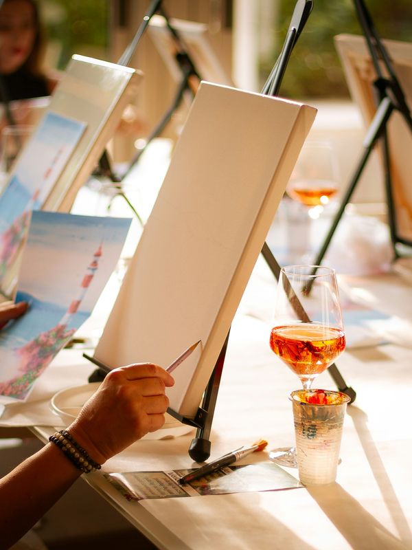 A painter at an easel during an outdoor painting session